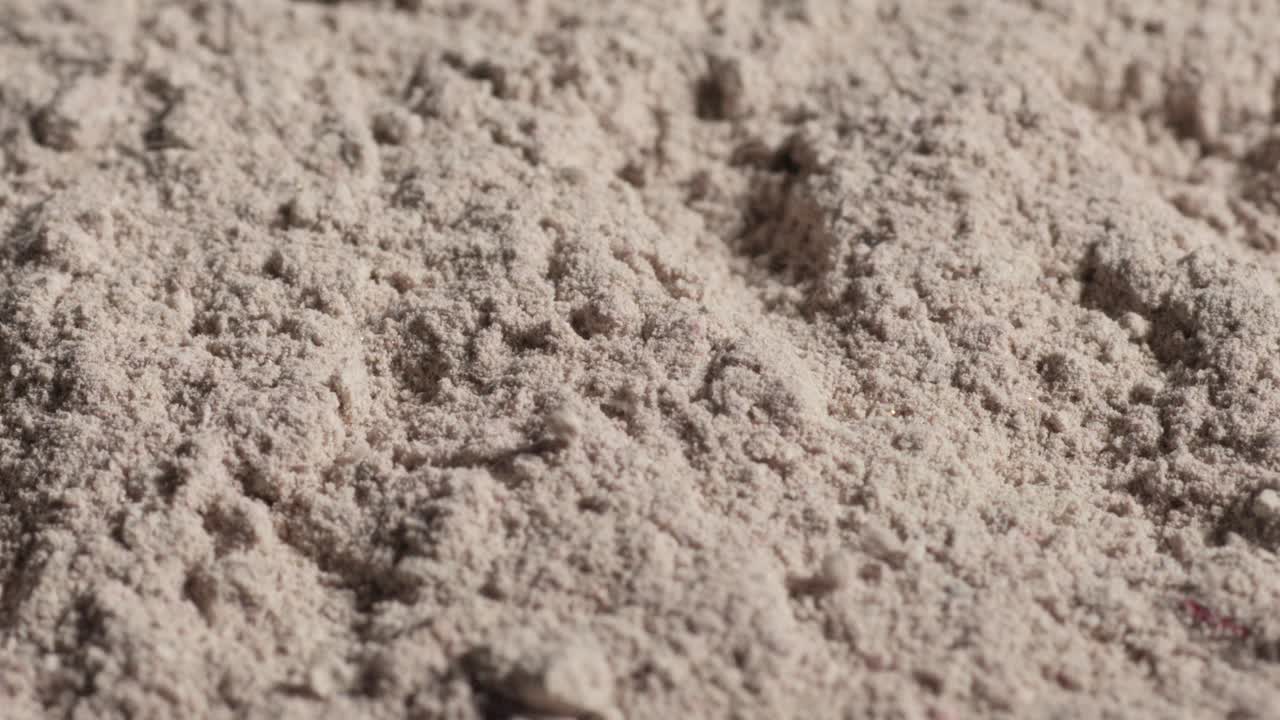 Fine, powdery flour with a textured surface, appearing soft and loosely packed