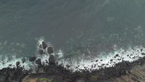 Drone-shot-of-waterfall-ending-in-a-sea-cliff-in-isle-of-skye-scotland