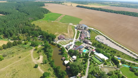 aerial view of a resort area with lake and farmland