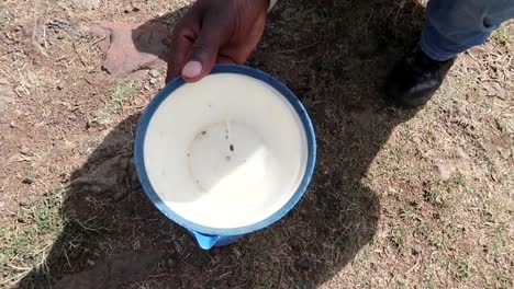 hand-held shot of an african man explaining how water runs in the southern hemisphere