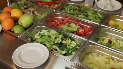 Self-service salad bar with various fresh fruits and vegetables