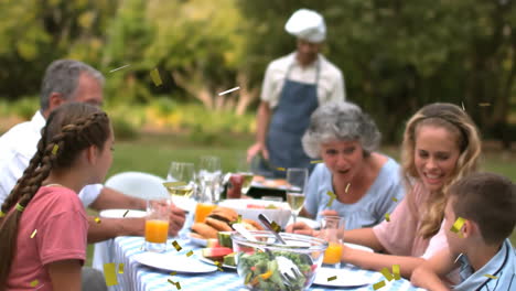 confetti animation over family enjoying outdoor meal at picnic table