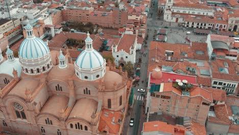 drone footage of cuenca, ecuador, showcasing its colonial architecture, cobblestone streets, and red-tiled roofs. aerial views of the historic city, unesco landmarks, and stunning andean backdrop