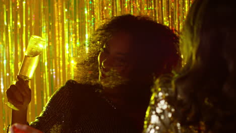 Close-Up-Of-Two-Women-Dancing-In-Nightclub-Bar-Or-Disco-Drinking-Alcohol-With-Sparkling-Lights-15