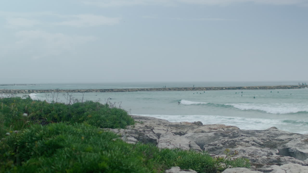A pier and waves rolling in.