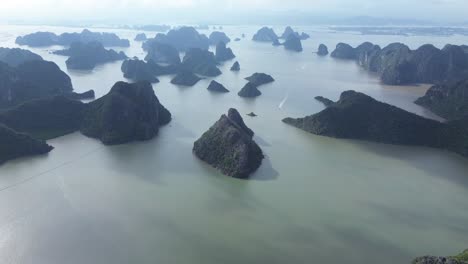 elevating camera angle showing limestone peaks and lush forest in cat ba national park
