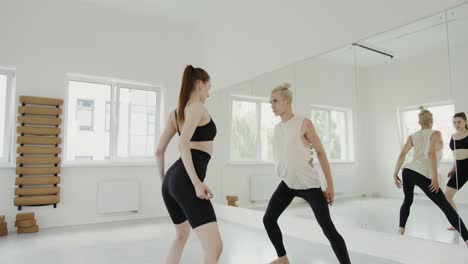 a man and woman dance in a studio