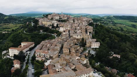 Drone shot tilting up to reveal Montepulciano, Tuscany in Italy&#039;s countryside