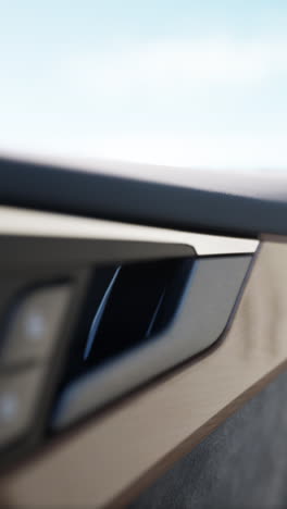 close up of a car door handle with chrome trim and wood trim