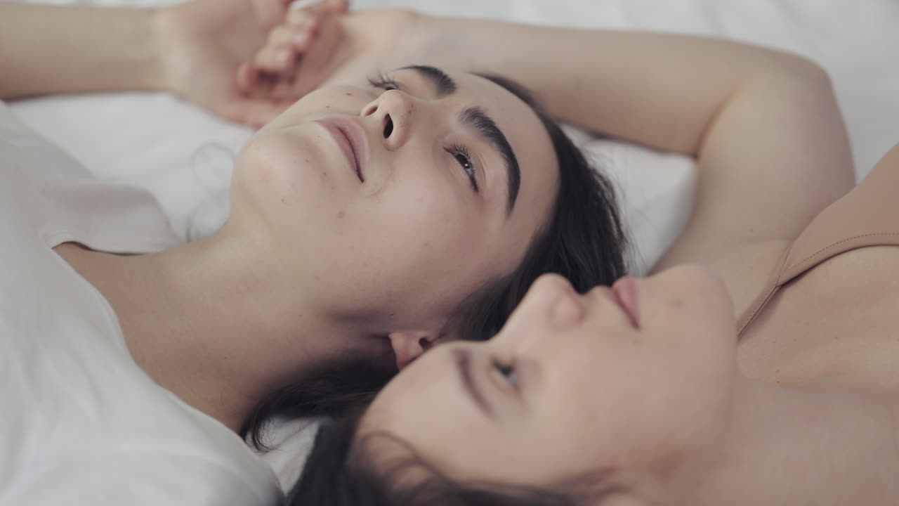 Two women sleeping in bed together