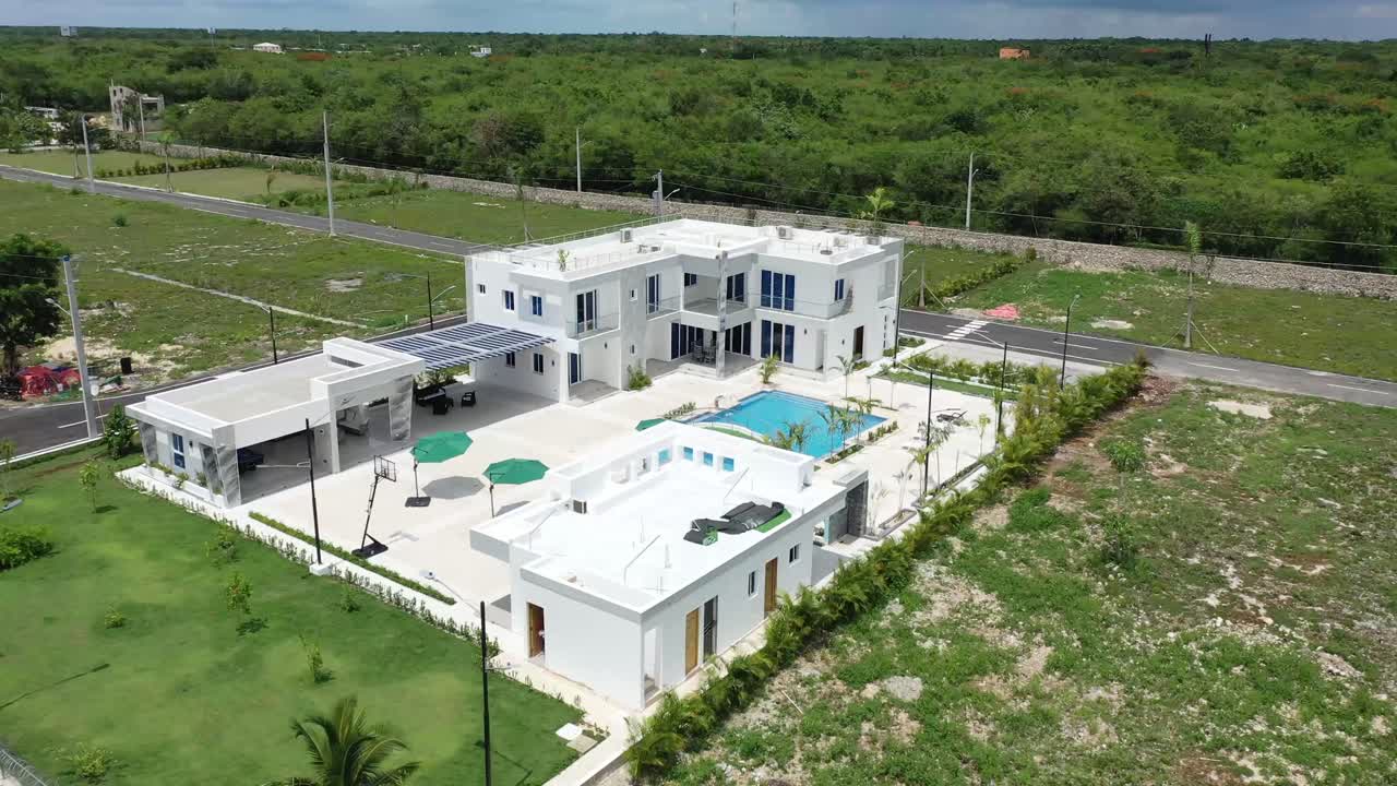 Drone view from afar of a villa in the Dominican Republic, beautiful countryside in the background