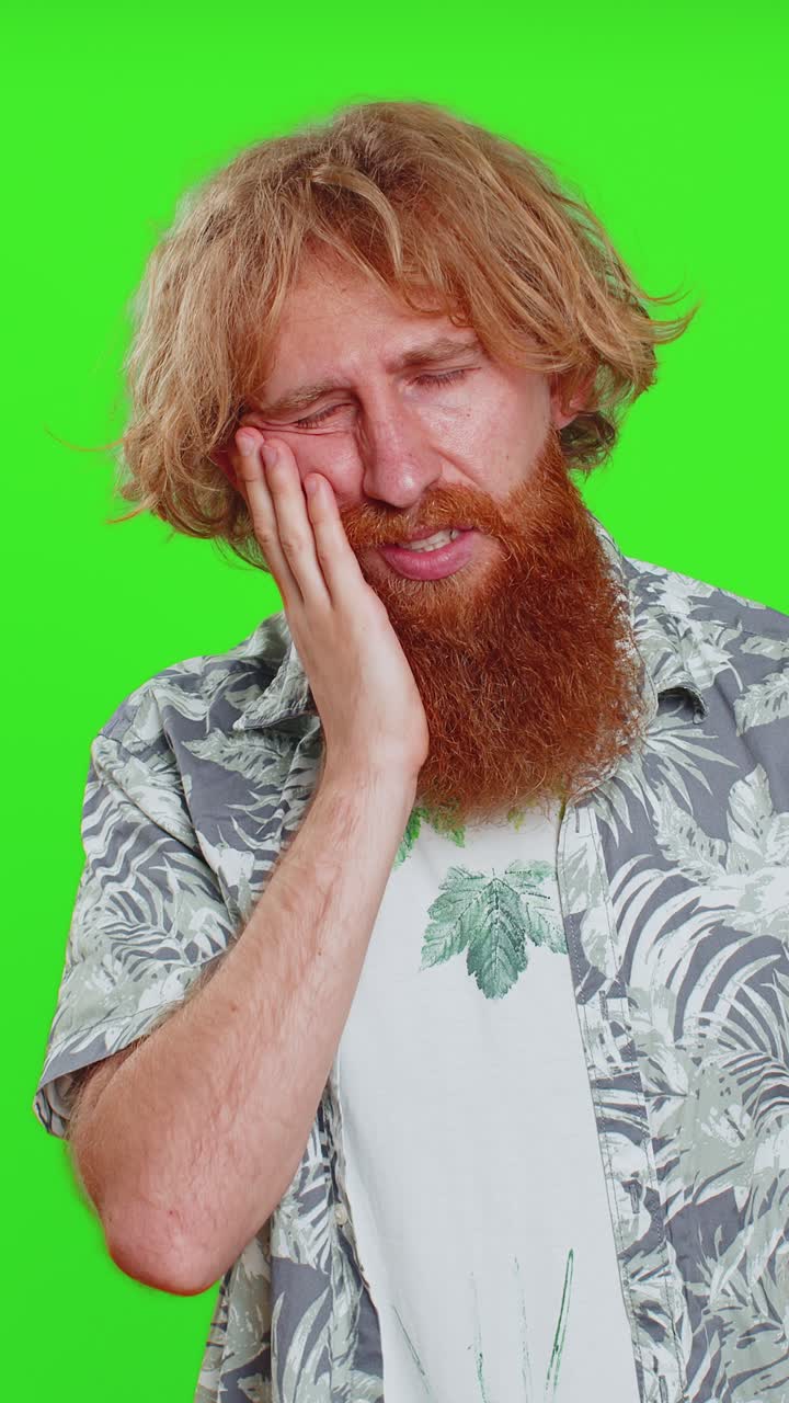 Young man touching cheek closing eyes with expression of terrible suffer from painful toothache