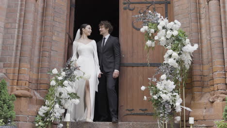 couple walking down church steps at wedding ceremony