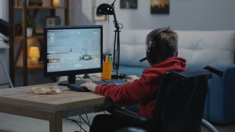 boy in wheelchair playing a space video game