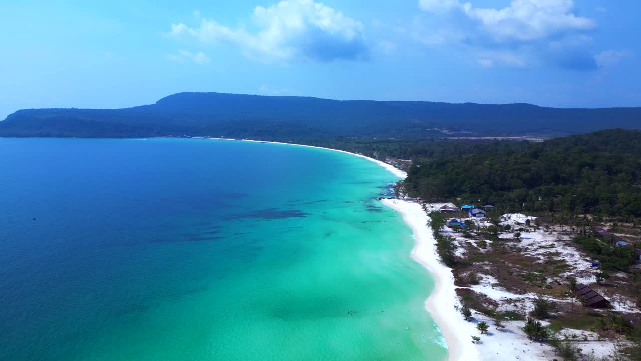 Sok San Beach with turquoise water washing the white sand, surrounded by palm trees and tropical vegetation. Amazing aerial view flight panorama overview drone