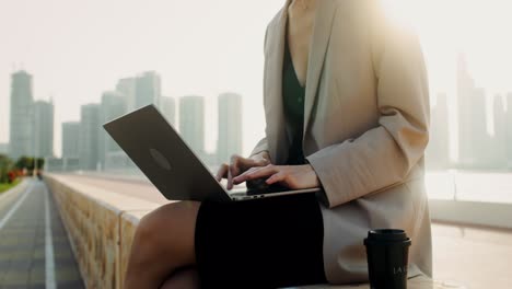 businesswoman working on a laptop outdoors