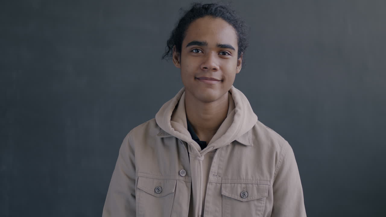 Young Man Smiling and Giving an Ok Sign