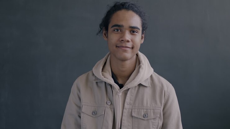 Young Man Smiling and Giving an Ok Sign