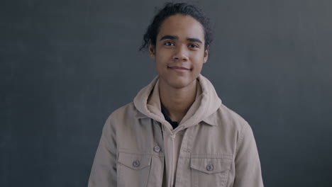 young man smiling and giving an ok sign