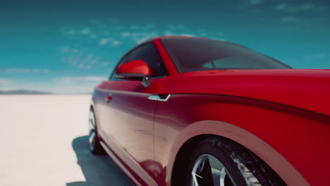 red sports car parked on a vast bright salt flat under a clear blue sky