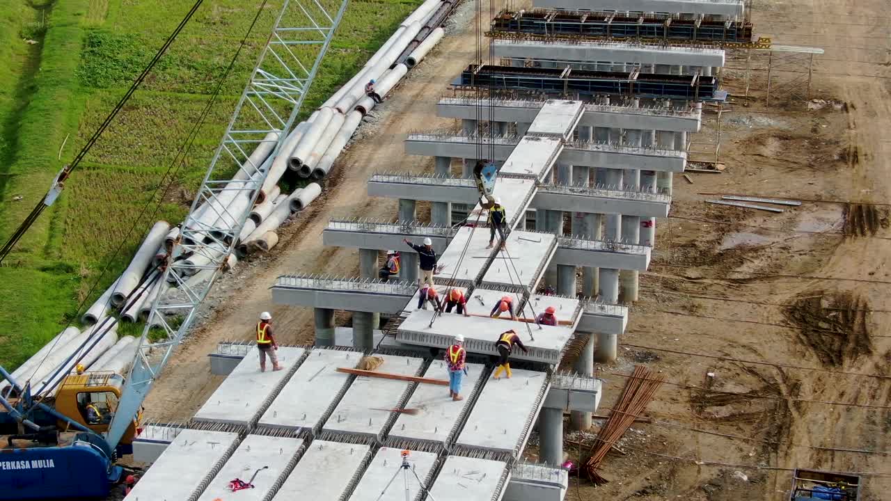 Aerial view of monorail construction site while assembling bridge floors, Java