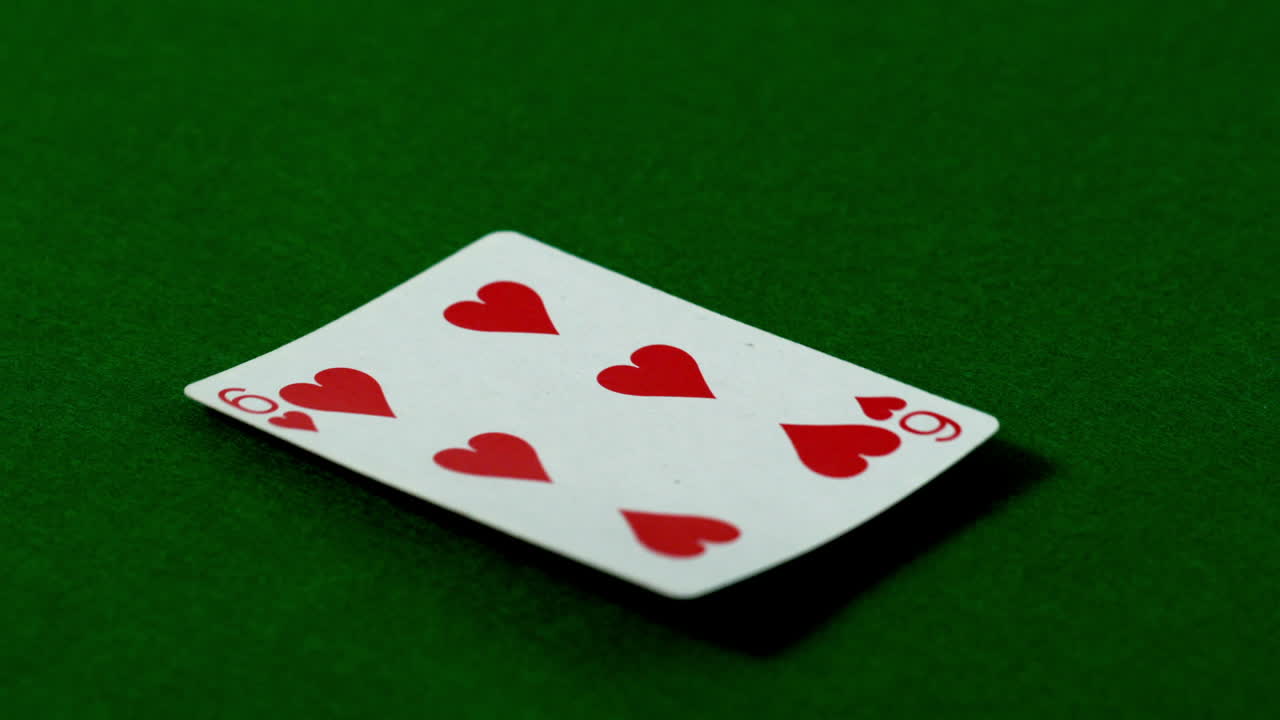 Six of hearts falling on casino table