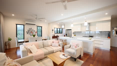 beige off white couch chairs and kitchen setting in luxurious open plan living and dining loungeroom