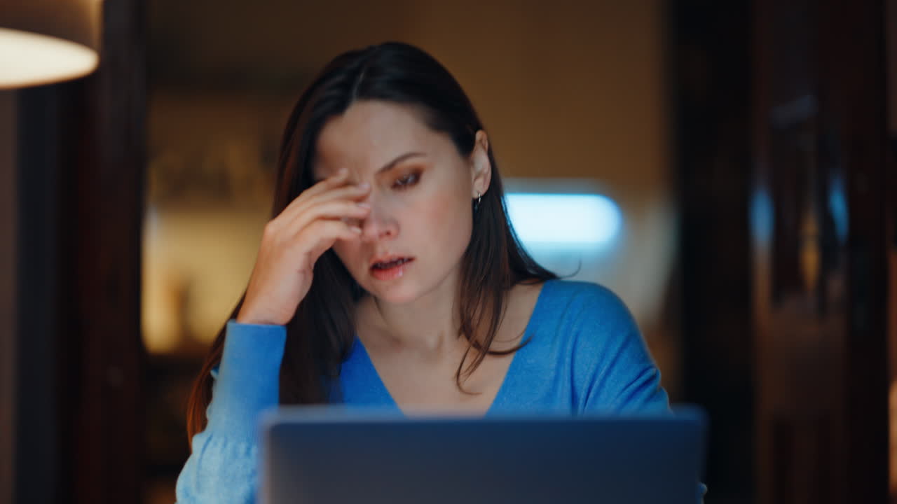 Dissatisfied manager arguing smartphone sitting dark home workplace closeup