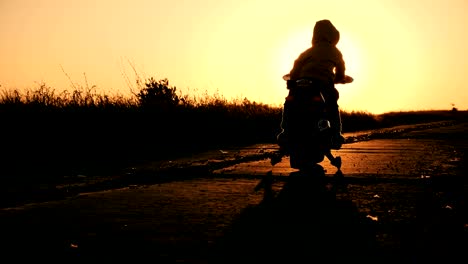 little boy is riding an electric motorcycle toy