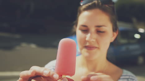 Man-holding-ice-lolly-point-of-view-woman-eating