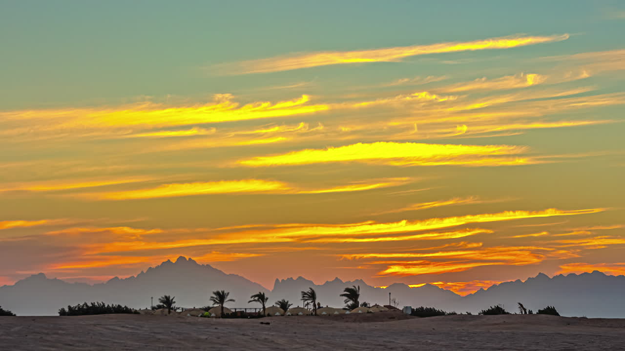 Timelapse shot of beautiful Egypt's arid desert landscape in distance with sun setting along yellow sky in the background