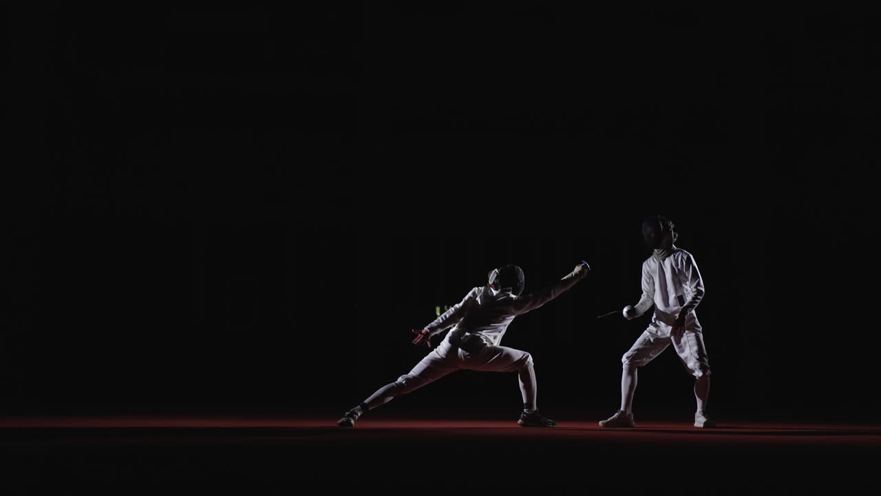 Two fencers competing in a match