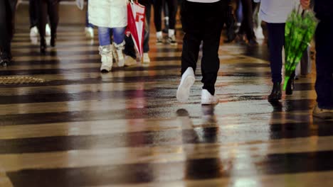 people crossing zebra crossing on a wet rainy day, people waking both sides, night, lights, umbrellas, niagara falls, canada