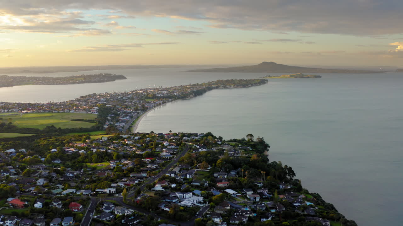 Aerial View of a Coastal Town and Bay at Sunset