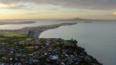 aerial view of a coastal town and bay at sunset