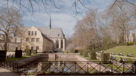 wide angle shot of the public garden of la cambre abbey on a sunny day - brussels, belgium