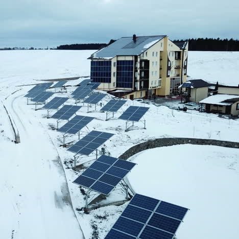recreation center with solar panels covered with snow on the outskirts of the city.