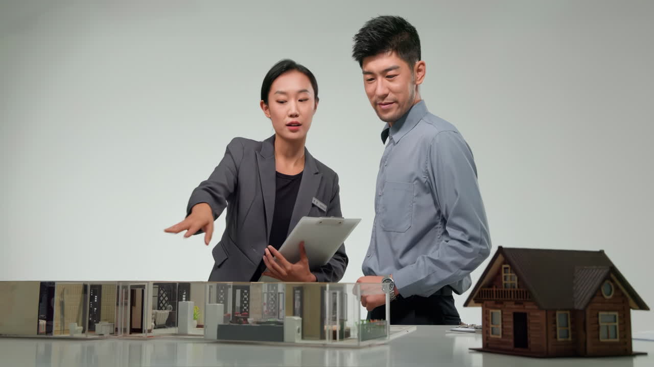 Salesman businessman consulted the design of model housing estate with apartment agency and discussed the terms of the real estate purchase agreement, get insurance or loan real estate or property