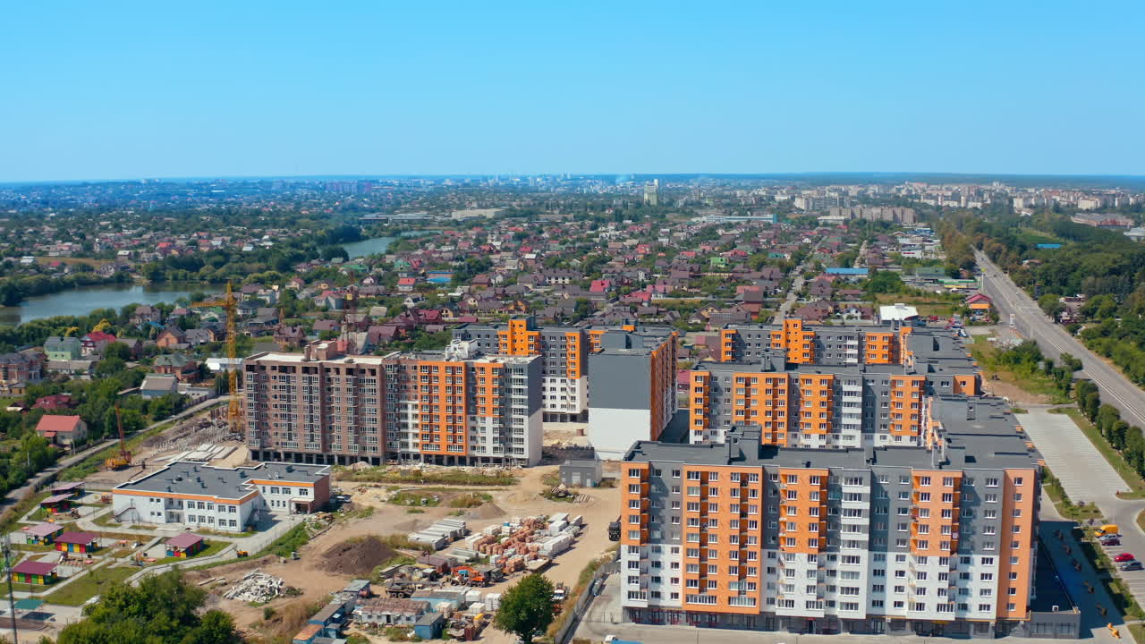 Modern architecture in the city. High rise buildings. Multi-storey buildings built in rural area near the river. View from above.