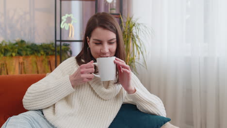 woman enjoying a hot beverage at home