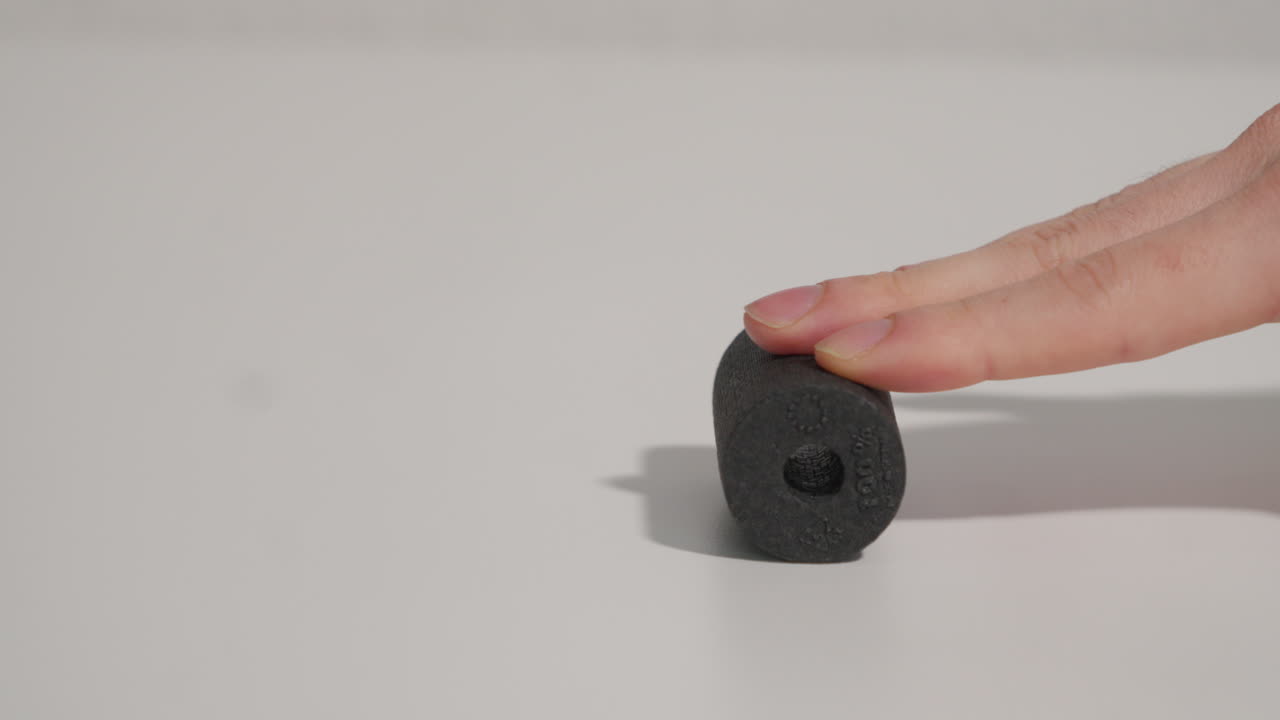 Close shot of a man's hand, massaging with a small foam roller