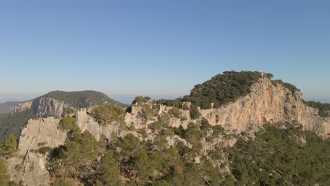 discover the stunning vistas of mallorca featuring the impressive castell de alaro perched on a rocky peak amidst the tramontana mountains. experience natural beauty and historical charm.