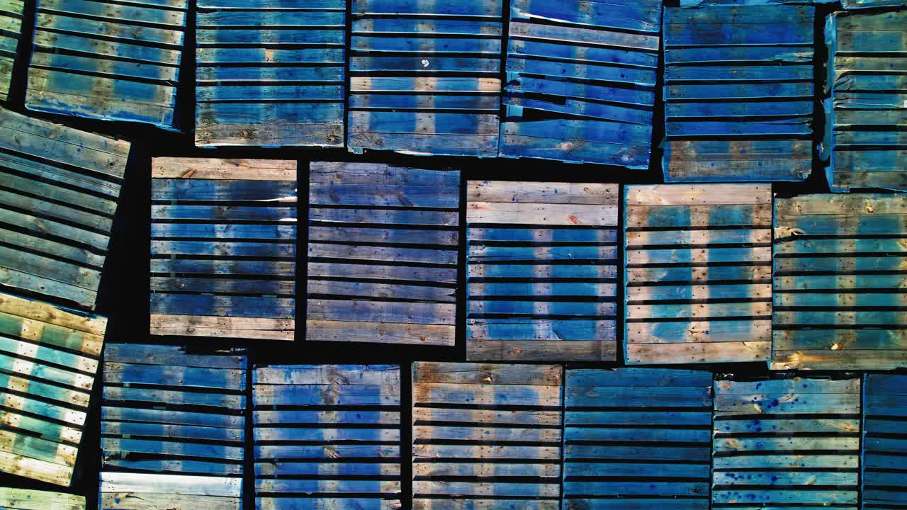 Top-Down Aerial View of Colorful Stacked Pallets in Industrial Storage Yard