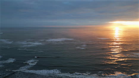 establishing aerial drone shot over sea at stunning sunrise in north yorkshire at low tide uk