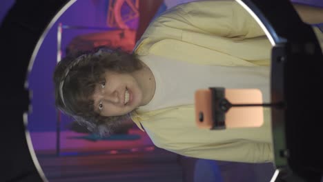 young man recording video content using ring light