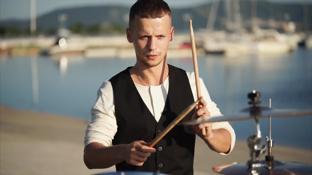 Drummer Playing Drums by the Harbor