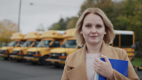 Portrait-of-a-woman-teacher-on-the-background-of-the-school-building