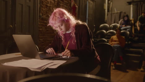 portrait of young female playwright working in theater