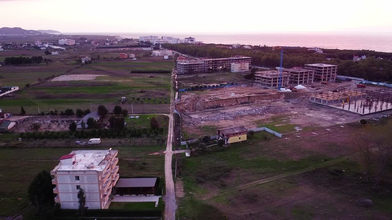 Aerial above new construction site and neighborhood in Golem, Albania.