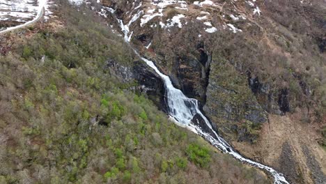 Grasteindalselva-river-close-to-Ornevegen-and-Korsmyra-in-Geiranger-Norway---Spring-aerial-during-snow-melting-and-water-flowing-to-Geiranger-fjord-sea